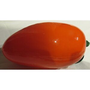 Glass orange pepper with green leaves fruit vegetable